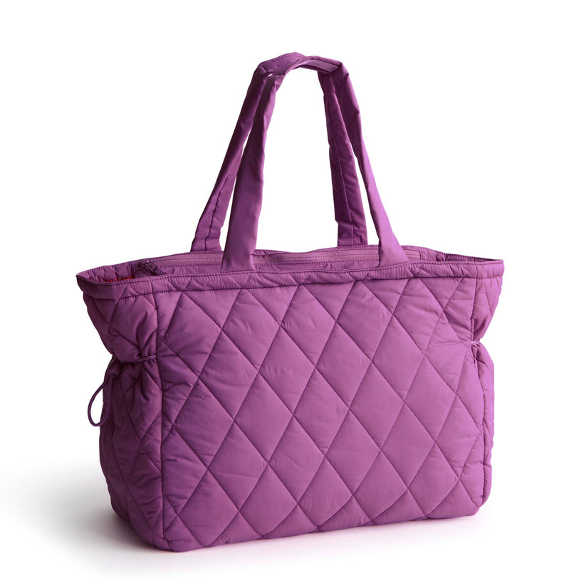 large quilted purple tote back with long handles and side cinches