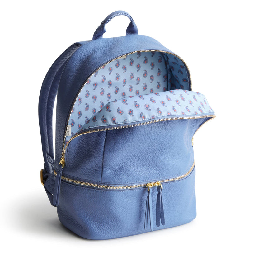 light blue leather diaper bag backpack unzipped to show paisley pattern inside