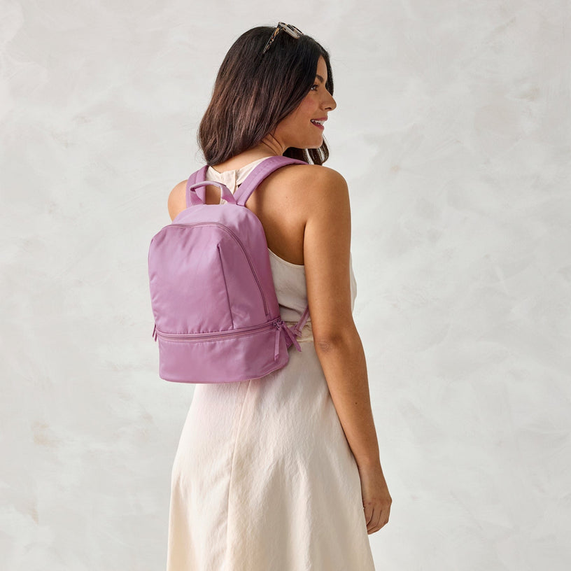 Model wearing light purple nylon backpack