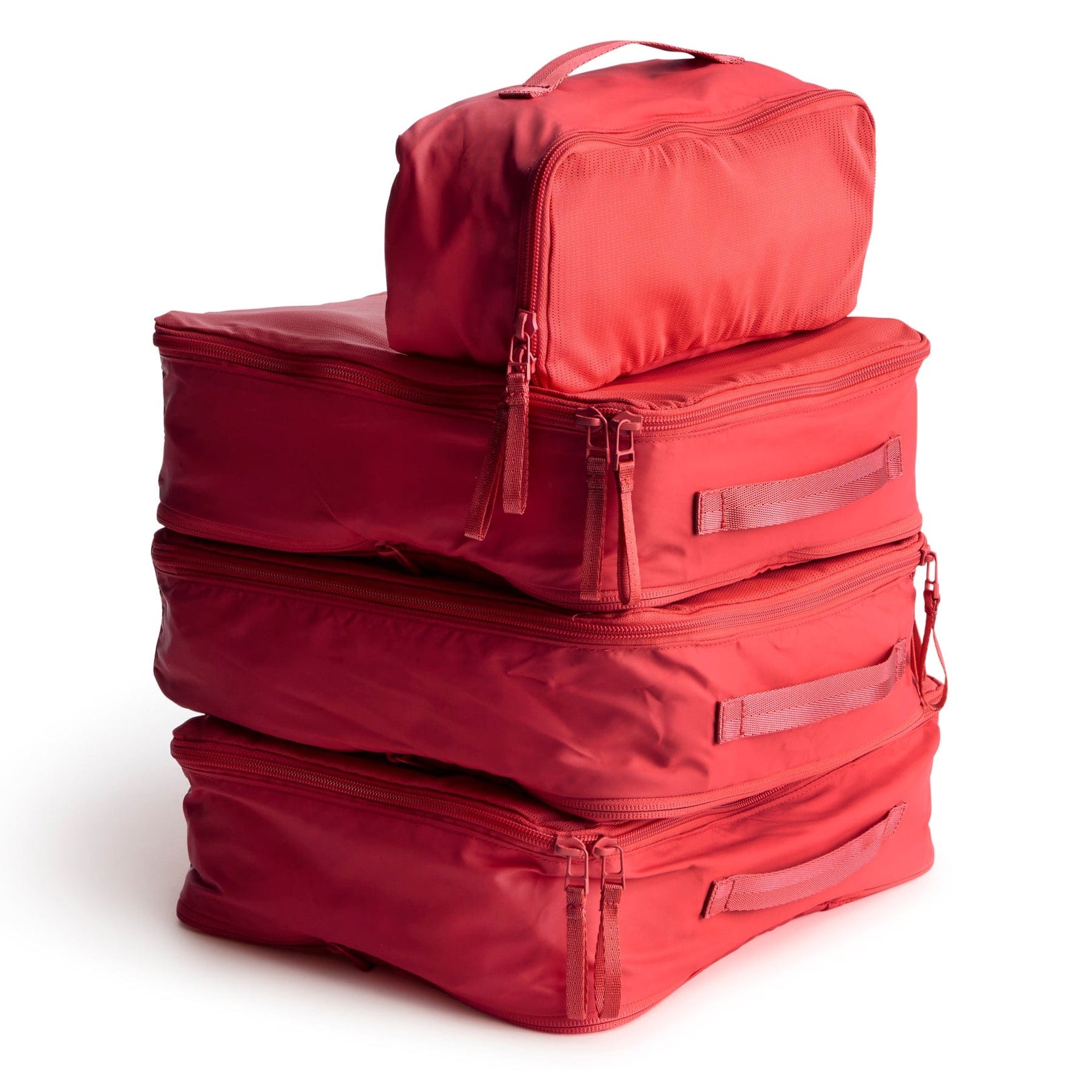 four red zippered packing cubes stacked on top of each other